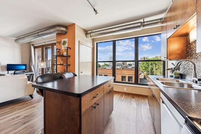 15 Franklin Ave Unit 312, Minneapolis, MN 55404 - kitchen with a sink, dark countertops, dishwasher, and plenty of natural light