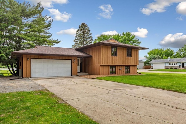 1930 6th Ave NE, Owatonna, MN 55060 - tri-level home with concrete driveway, a front yard, a garage, and board and batten siding