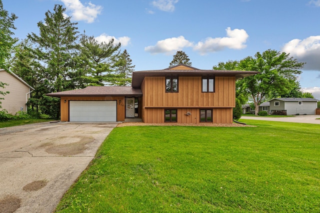 1930 6th Ave NE, Owatonna, MN 55060 - split level home featuring an attached garage, driveway, a front lawn, and board and batten siding