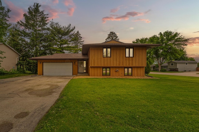 1930 6th Ave NE, Owatonna, MN 55060 - tri-level home featuring an attached garage, driveway, a yard, and board and batten siding