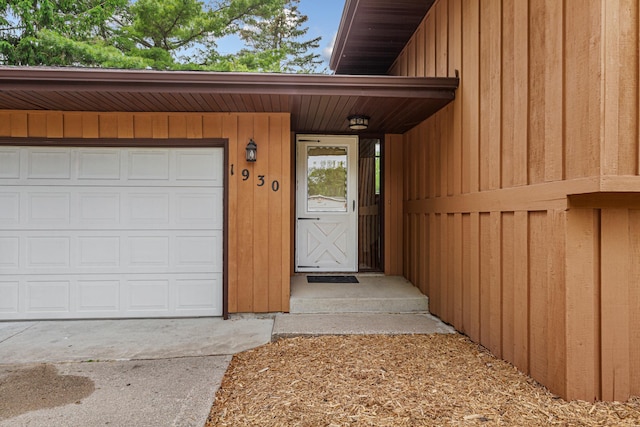 1930 6th Ave NE, Owatonna, MN 55060 - doorway to property with an attached garage and concrete driveway