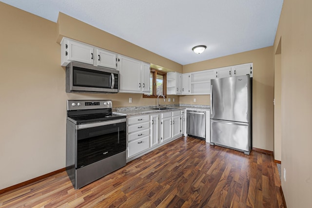1930 6th Ave NE, Owatonna, MN 55060 - kitchen with stainless steel appliances, a sink, open shelves, white cabinets, and baseboards