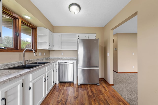 1930 6th Ave NE, Owatonna, MN 55060 - kitchen with stainless steel appliances, a sink, open shelves, white cabinetry, and a textured ceiling