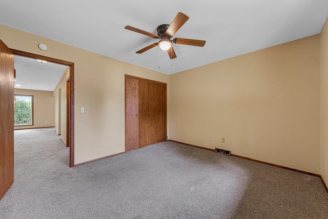 1930 6th Ave NE, Owatonna, MN 55060 - unfurnished bedroom with carpet, baseboards, a closet, and a ceiling fan