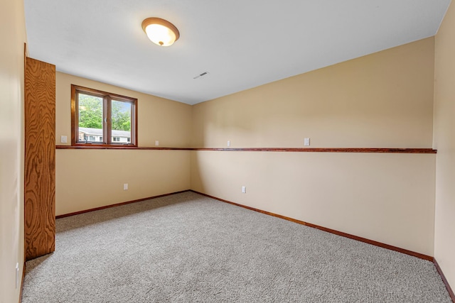 1930 6th Ave NE, Owatonna, MN 55060 - spare room featuring carpet flooring and baseboards