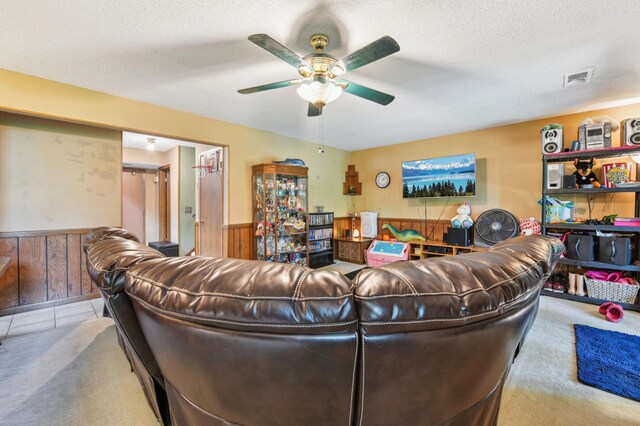 1351 4th St W, Hastings, MN 55033 - carpeted living area with a ceiling fan, a wainscoted wall, and a textured ceiling
