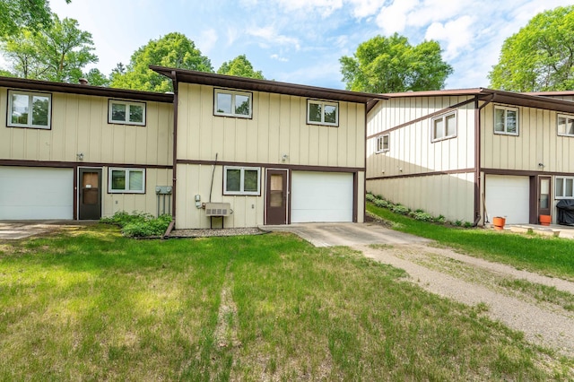 415 2nd Ave SE, Pelican Rapids, MN 56572 - view of front of house with a front lawn, driveway, and board and batten siding