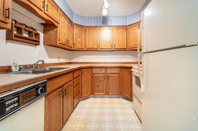 415 2nd Ave SE, Pelican Rapids, MN 56572 - kitchen featuring white appliances, a sink, brown cabinets, light countertops, and light flooring