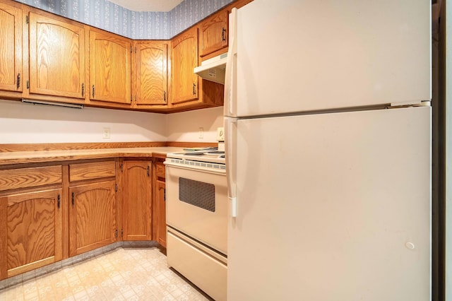 415 2nd Ave SE, Pelican Rapids, MN 56572 - kitchen featuring white appliances, under cabinet range hood, light flooring, brown cabinets, and wallpapered walls