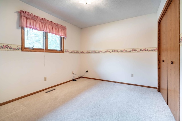 415 2nd Ave SE, Pelican Rapids, MN 56572 - empty room featuring carpet flooring, baseboards, and a textured ceiling
