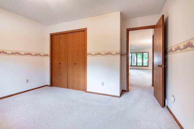 415 2nd Ave SE, Pelican Rapids, MN 56572 - unfurnished bedroom with light colored carpet, a closet, and baseboards
