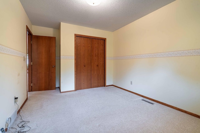 415 2nd Ave SE, Pelican Rapids, MN 56572 - unfurnished bedroom featuring a closet, carpet, a textured ceiling, and baseboards