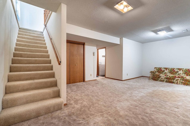 415 2nd Ave SE, Pelican Rapids, MN 56572 - basement with stairs, carpet floors, a textured ceiling, baseboards, and washer / dryer