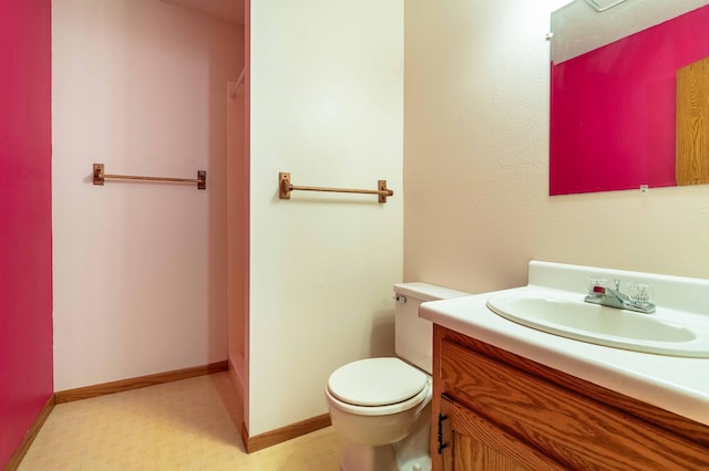 415 2nd Ave SE, Pelican Rapids, MN 56572 - bathroom featuring vanity, toilet, and baseboards