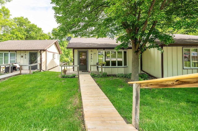 415 2nd Ave SE, Pelican Rapids, MN 56572 - view of front of property featuring a front yard, board and batten siding, and a shingled roof