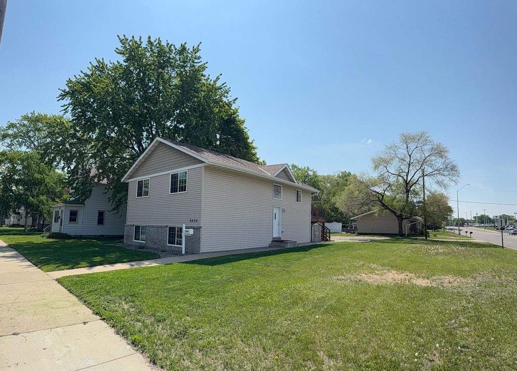 2434 1st St S, Saint Cloud, MN 56301 - view of property exterior with a yard