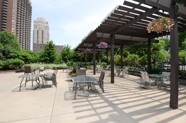 15 1st St Unit A1119, Minneapolis, MN 55401 - view of community with a pergola, a view of city, outdoor dining space, and a patio area