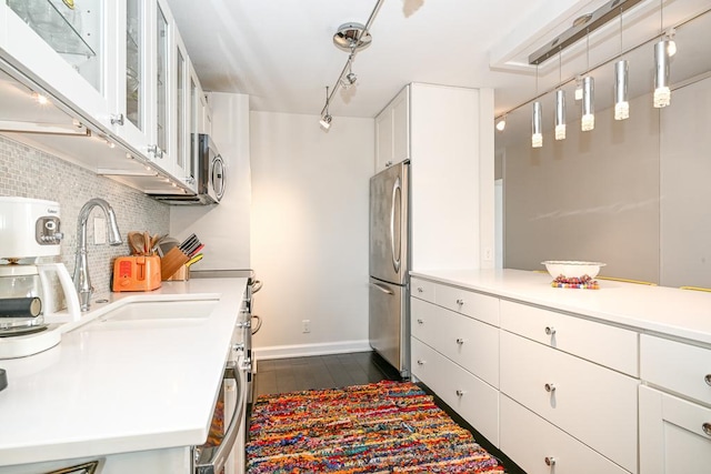 15 1st St Unit A1119, Minneapolis, MN 55401 - kitchen with appliances with stainless steel finishes, a sink, tasteful backsplash, white cabinetry, and dark wood-type flooring
