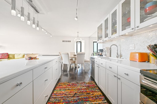 15 1st St Unit A1119, Minneapolis, MN 55401 - kitchen featuring a sink, track lighting, light countertops, appliances with stainless steel finishes, and a chandelier