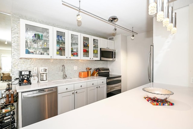 15 1st St Unit A1119, Minneapolis, MN 55401 - kitchen with appliances with stainless steel finishes, a sink, light countertops, and decorative backsplash