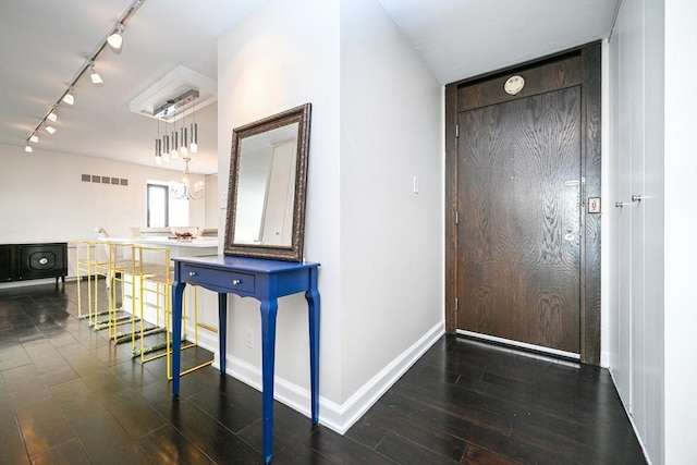 15 1st St Unit A1119, Minneapolis, MN 55401 - corridor with rail lighting, wood finished floors, baseboards, and a chandelier