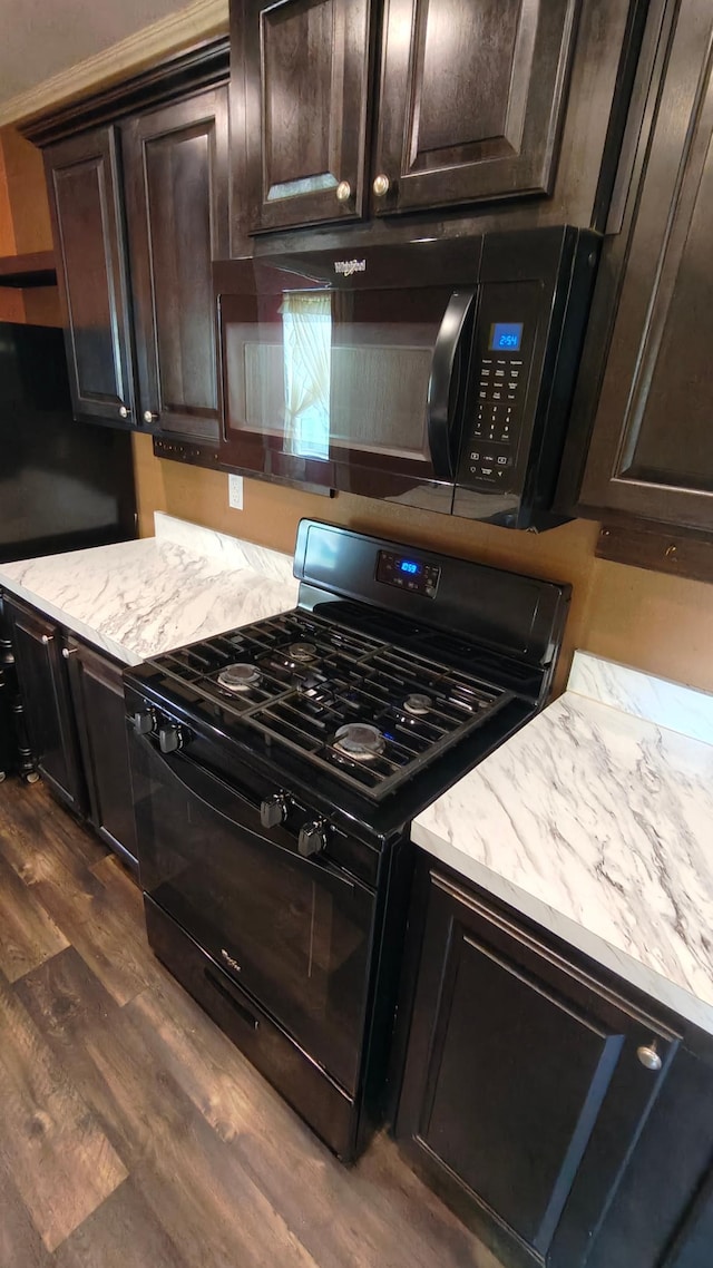 13786 188th Pl, Williams Twp, MN 56350 - kitchen with black appliances, dark wood-style flooring, dark brown cabinets, and light stone counters