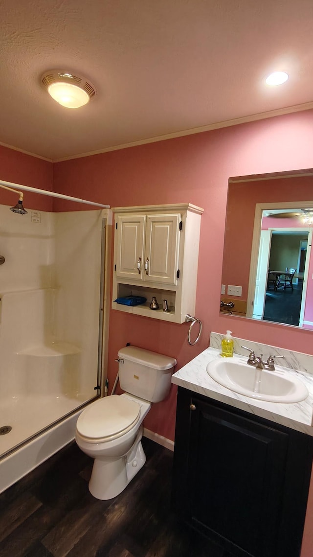 13786 188th Pl, Williams Twp, MN 56350 - bathroom with a shower stall, vanity, toilet, wood finished floors, and crown molding
