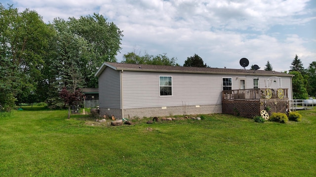 13786 188th Pl, Williams Twp, MN 56350 - rear view of house featuring a deck, a yard, and crawl space