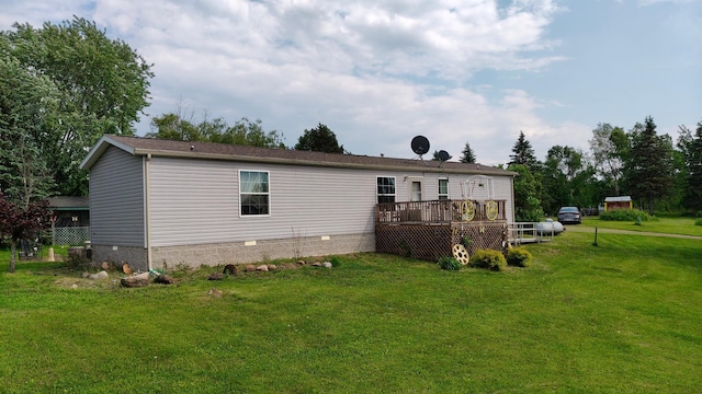 13786 188th Pl, Williams Twp, MN 56350 - rear view of house with crawl space, a wooden deck, and a yard