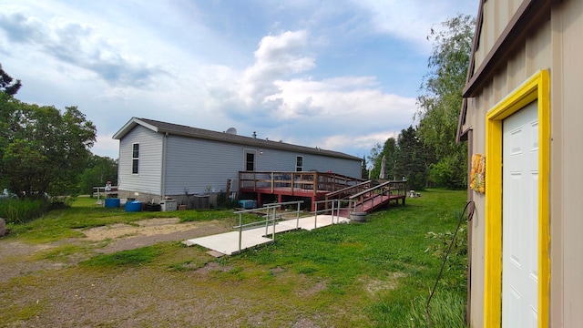 13786 188th Pl, Williams Twp, MN 56350 - rear view of property with a deck, a lawn, and a patio