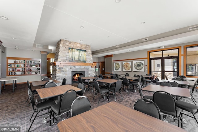 11206 Baltimore St NE Unit A, Blaine, MN 55449 - carpeted dining room featuring a stone fireplace, decorative columns, and recessed lighting