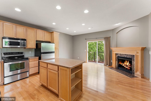 11206 Baltimore St NE Unit A, Blaine, MN 55449 - kitchen with appliances with stainless steel finishes, light brown cabinetry, light wood-style flooring, open floor plan, and recessed lighting