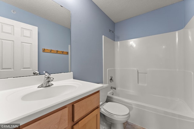 11206 Baltimore St NE Unit A, Blaine, MN 55449 - bathroom featuring a textured ceiling, toilet, vanity, shower / tub combination, and tile patterned flooring