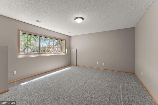 11206 Baltimore St NE Unit A, Blaine, MN 55449 - carpeted empty room with baseboards, a textured ceiling, and a smoke detector