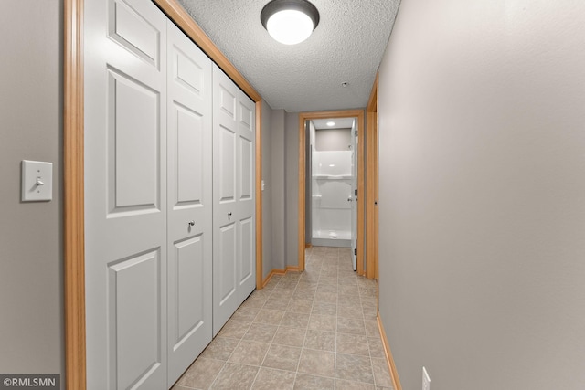 11206 Baltimore St NE Unit A, Blaine, MN 55449 - hallway with a textured ceiling, baseboards, and light tile patterned floors