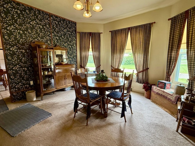 2100 Trott Ave SW, Willmar, MN 56201 - dining space featuring a chandelier, light colored carpet, plenty of natural light, and ornamental molding