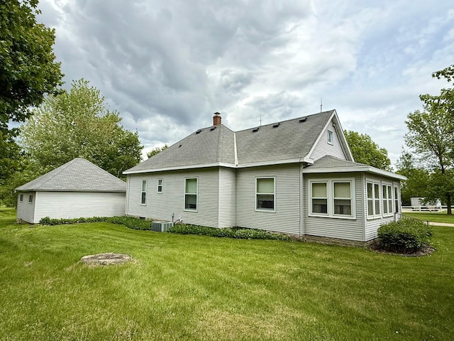2100 Trott Ave SW, Willmar, MN 56201 - back of property with a lawn, a chimney, and a shingled roof
