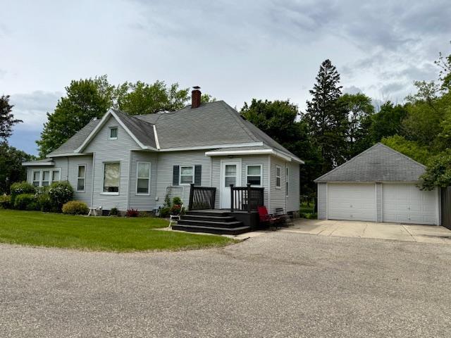 2100 Trott Ave SW, Willmar, MN 56201 - view of front of property with an outbuilding, a detached garage, a chimney, and a front lawn
