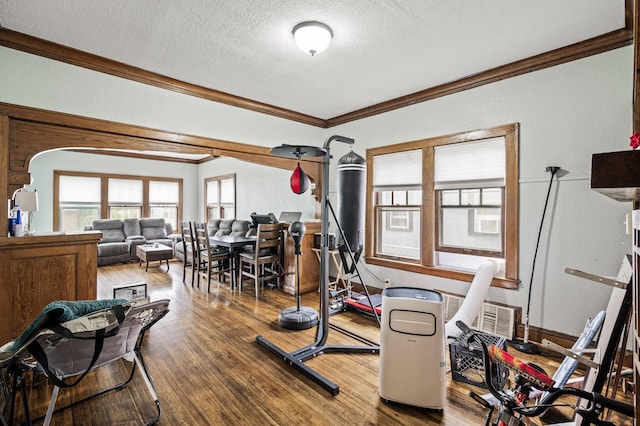 3725 Fremont Ave N, Minneapolis, MN 55412 - workout area featuring crown molding, a textured ceiling, and wood finished floors
