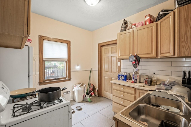 3725 Fremont Ave N, Minneapolis, MN 55412 - kitchen featuring white appliances, a sink, decorative backsplash, light brown cabinetry, and light tile patterned flooring