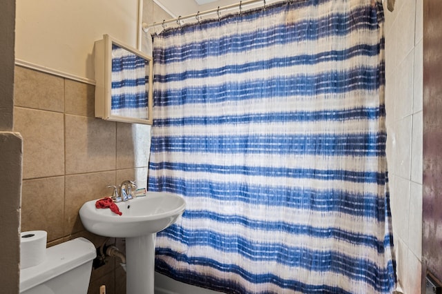 3725 Fremont Ave N, Minneapolis, MN 55412 - bathroom with tile walls, toilet, and a shower with shower curtain