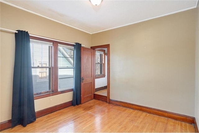 3725 Fremont Ave N, Minneapolis, MN 55412 - empty room with baseboards, light wood-style floors, and crown molding