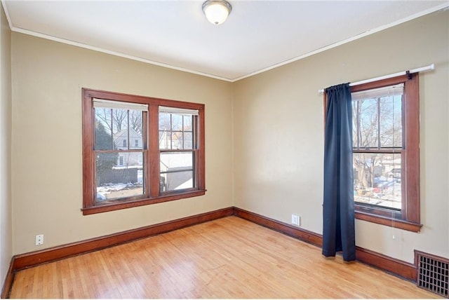 3725 Fremont Ave N, Minneapolis, MN 55412 - empty room featuring light wood-style floors, baseboards, and crown molding