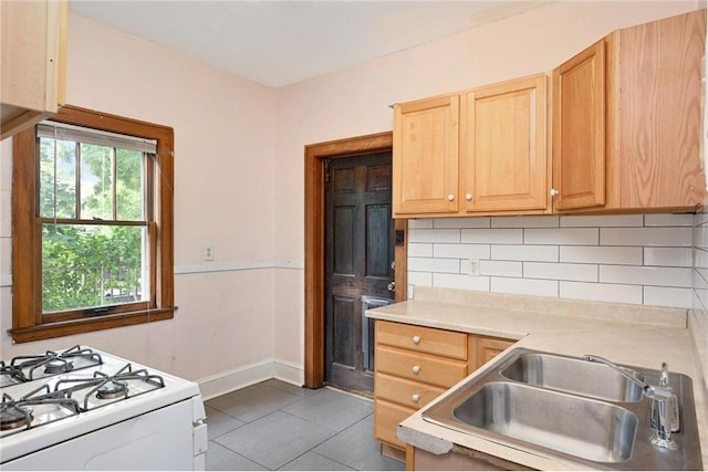 3725 Fremont Ave N, Minneapolis, MN 55412 - kitchen featuring a sink, decorative backsplash, light countertops, tile patterned flooring, and light brown cabinetry
