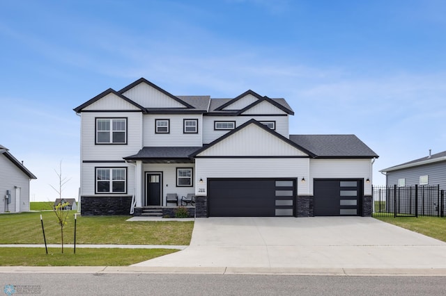 2818 14th St W, West Fargo, ND 58078 - view of front of house with a garage, stone siding, driveway, and board and batten siding