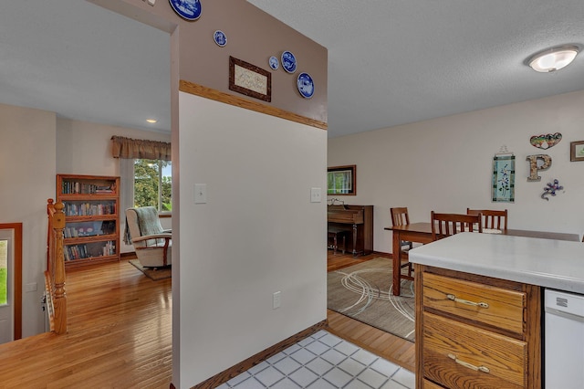 11236 207th Ave NW, Elk River, MN 55330 - kitchen with white dishwasher, light countertops, light wood finished floors, and baseboards