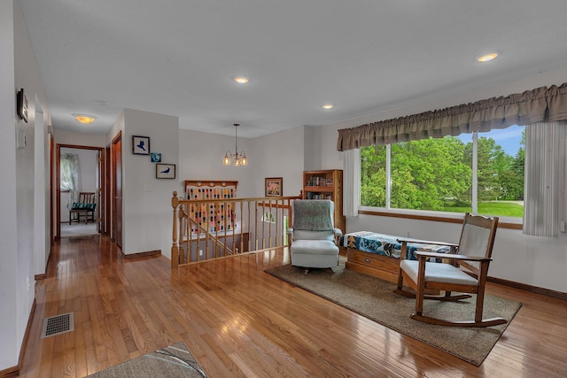 11236 207th Ave NW, Elk River, MN 55330 - living area with an upstairs landing, wood-type flooring, baseboards, recessed lighting, and a chandelier