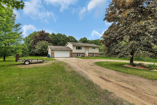 11236 207th Ave NW, Elk River, MN 55330 - view of front of home with dirt driveway, brick siding, a garage, and a front yard