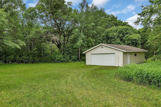 11236 207th Ave NW, Elk River, MN 55330 - view of grassy yard with a detached garage, an outbuilding, and a wooded view