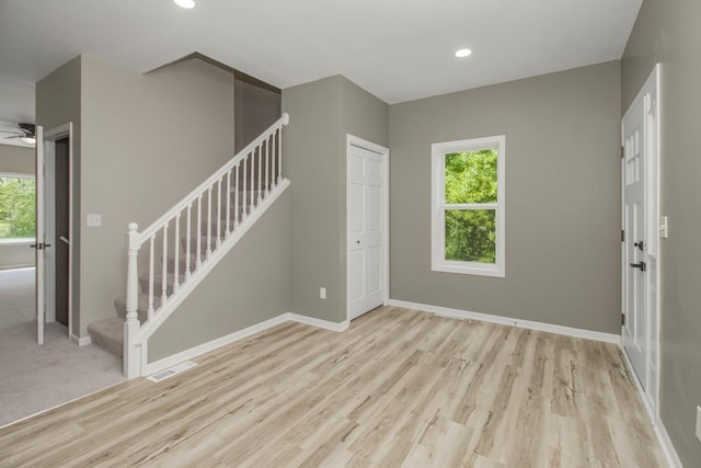 7658 Silver Lake Rd, Mounds View, MN 55112 - entryway featuring stairway, wood finished floors, baseboards, recessed lighting, and a ceiling fan